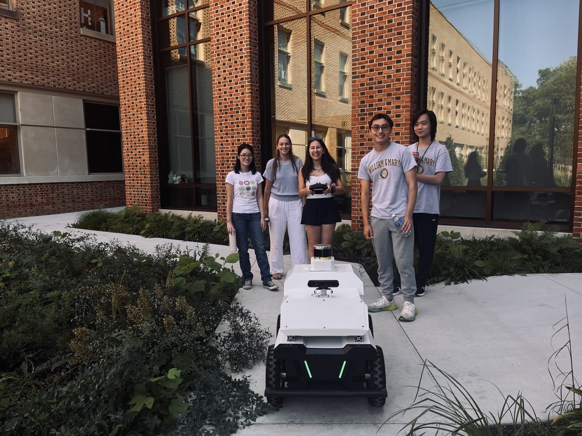 Students teleoperating the robotic vehicle on a campus walkway