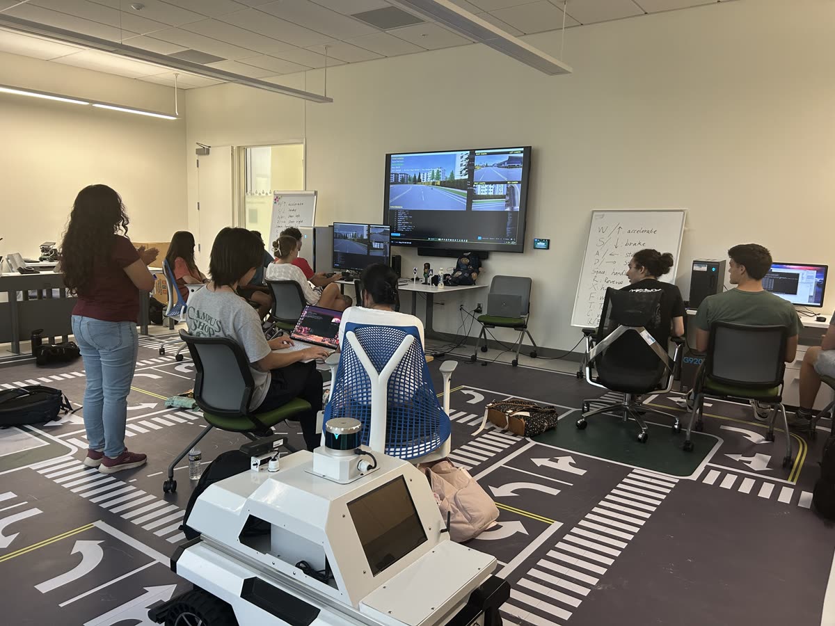 Students discussing simulation results shown on the lab screen