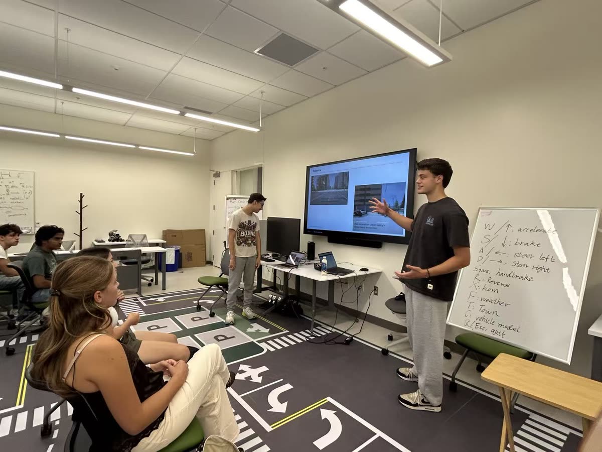 A student presenting a team demonstration to the class
